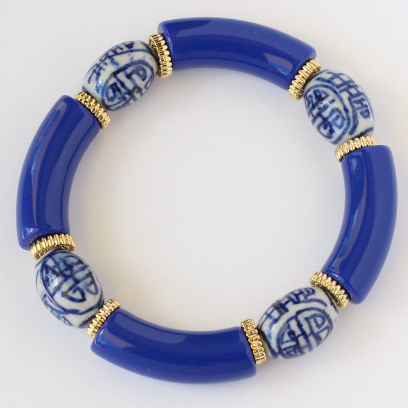 cobalt blue and gold beaded bracelet featuring handapinted blue and white chinoiserie beads.  This blue and gold stretch bracelet is a custom made beaded bracelet